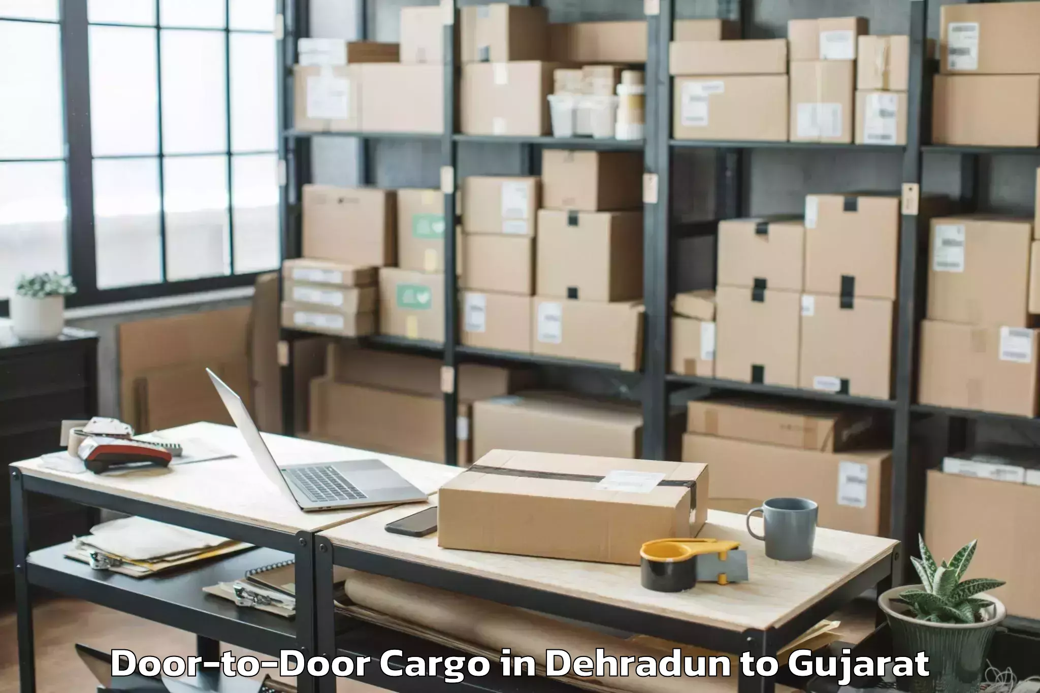 Leading Dehradun to Kamrej Door To Door Cargo Provider